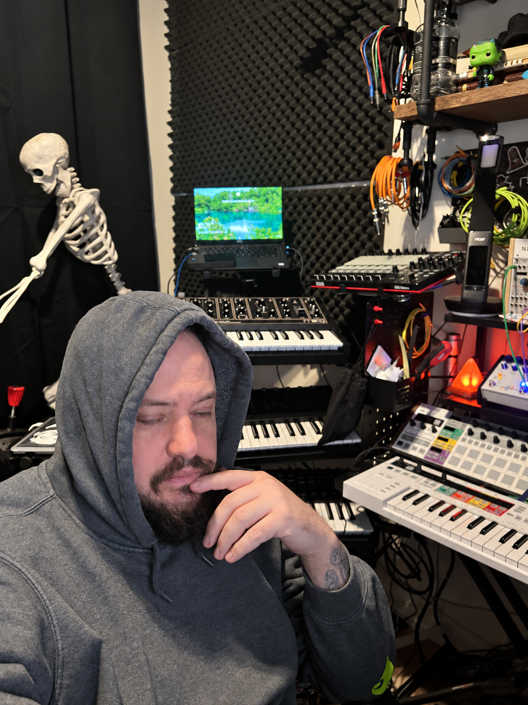 Feral Business working among synthesizers and studio equipment